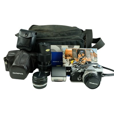 Lot 605 - An Olympus OM-2n SLR film camera, cased with...