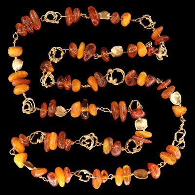 Lot 1397 - A Modernist artisanal amber chip-bead and 18...