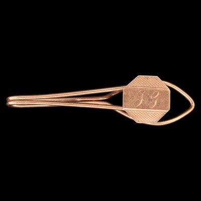 Lot 1403 - A 1950s 9 ct gold tie clip, comprising a...