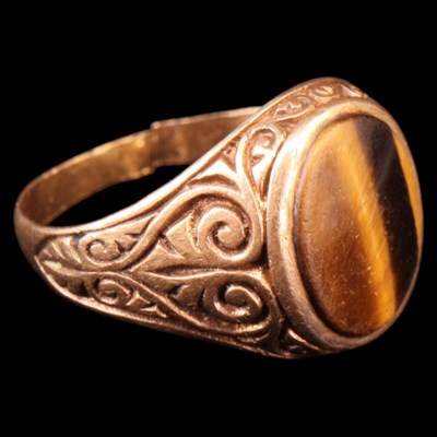 Lot 1408 - A 1970s tiger's eye signet ring, the gemstone...