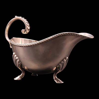 Lot 1146 - A George V silver sauce boat, having a...