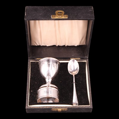 Lot 1163 - A cased 1950 silver egg cup, spoon and napkin...