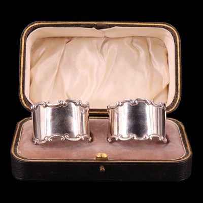 Lot 1164 - A Belle Epoque cased pair of silver napkin...