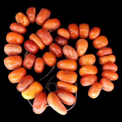 Lot 1417 - A natural butterscotch amber nodule bead...