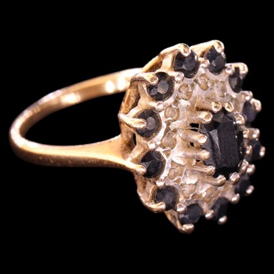 Lot 1454 - A 1980s diamond and sapphire cluster...