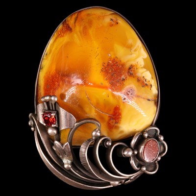 Lot 1504 - A large amber nodule brooch, bezel-set...