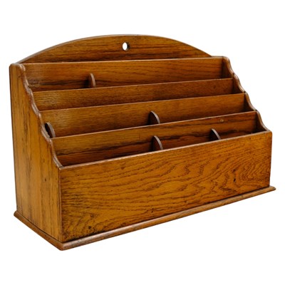 Lot 825 - An early 20th Century oak stationery rack, 26...