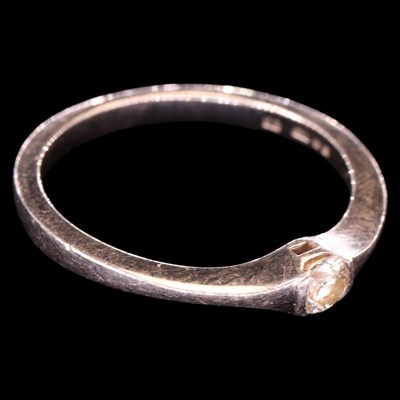 Lot 1469 - A contemporary diamond and platinum engagement...