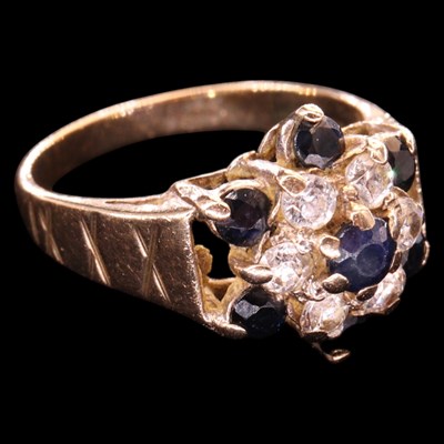 Lot 1478 - A 1980s sapphire and white gemstone flowerhead...