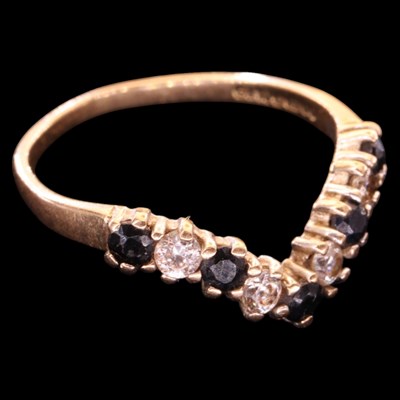 Lot 1482 - A 1990s sapphire and white gemstone wishbone...