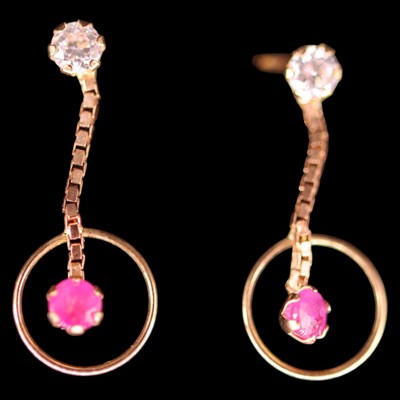 Lot 1488 - A pair of contemporary ruby, white gemstone...