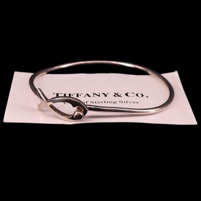 Lot 1498 - A Tiffany & Co white metal bangle, having an...