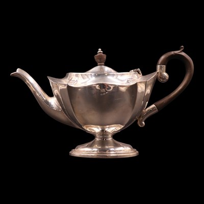 Lot 1215 - An Edwardian silver teapot, of panelled...