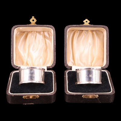 Lot 1222 - A pair of cased George V silver napkin...