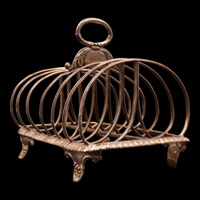 Lot 1233 - A George IV silver six-slice toast rack,...