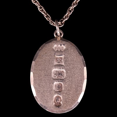 Lot 1361 - A 1977 heavy silver oval pendant and neck...