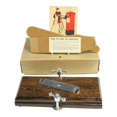 Lot 783 - A vintage tie press, in original carton with...