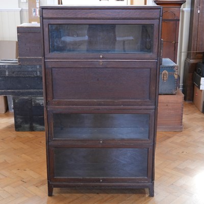 Lot 1676 - An early 20th Century oak sectional fall-front...