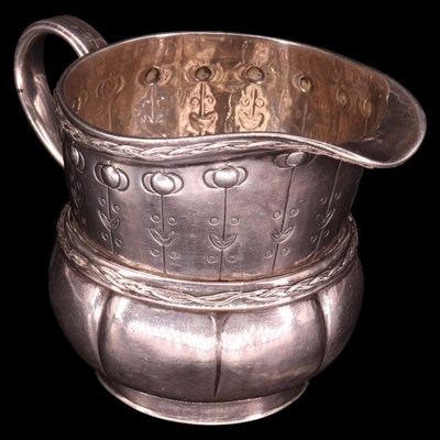 Lot 1130F - An Edwardian Arts and Crafts silver cream jug,...
