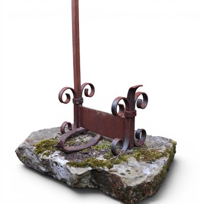 Lot 1448 - A wrought-iron boot scraper set in rough-hewn...