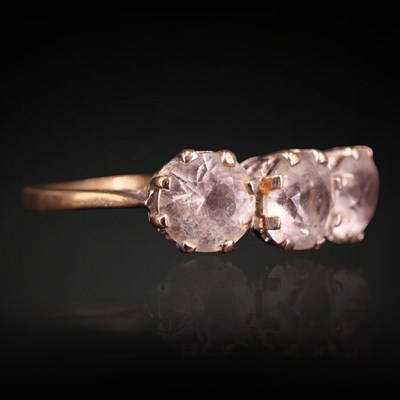 Lot 1276 - A 1970s three-stone ring, comprising a row of...