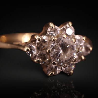 Lot 1279 - A 1980s white gemstone flowerhead cluster ring,...