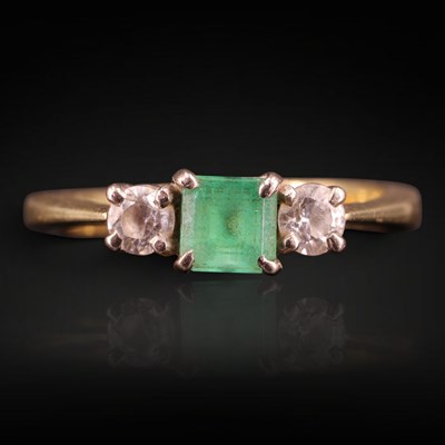 Lot 1281 - A late 20th Century emerald and white gemstone...