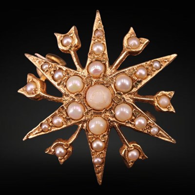 Lot 1292 - A 1970s seed-pearl and 9 ct gold starburst...