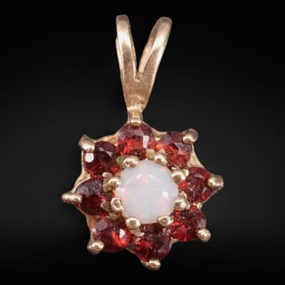 Lot 1295 - A 1980s opal, almandine and 9 ct gold...