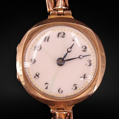 Lot 1353 - A lady's 1920s 9 ct gold wristlet watch on a...
