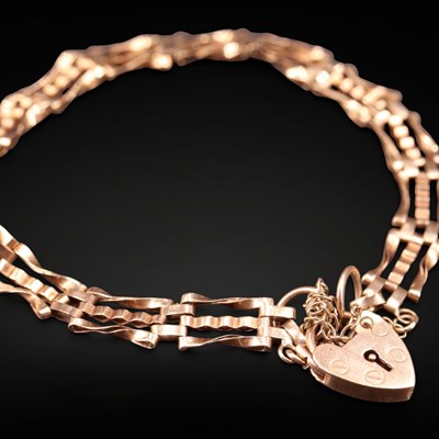 Lot 1299 - A 1980s 9 ct gold gate-link bracelet, having a...