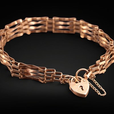 Lot 1244 - A 1980s 9 ct gold gate-link bracelet, having a...