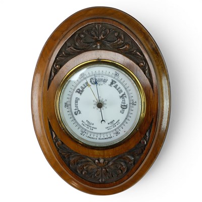 Lot 1369 - An early 20th Century carved walnut aneroid...