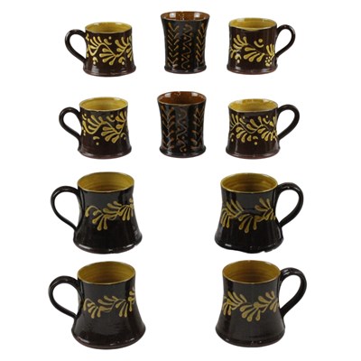 Lot 900 - Wetheriggs Pottery mugs and beakers, yellow...