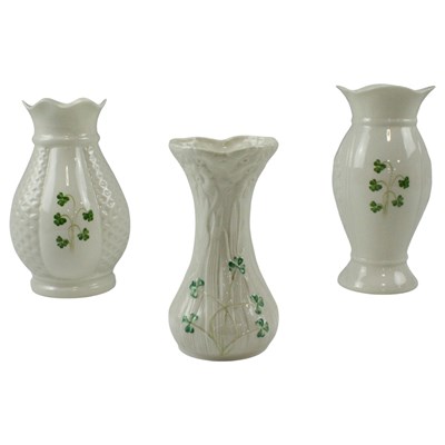 Lot 943 - A Belleek shamrock vase together with two...