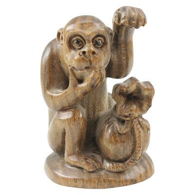 Lot 891 - A Japanese carved wooden okimono of a bemused...