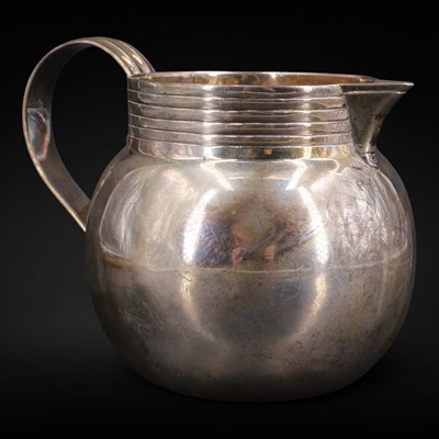Lot 1119 - A George V silver milk jug, of oblate form...