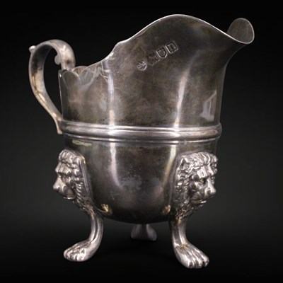 Lot 1127 - An Edwardian silver cream jug, having a shaped...