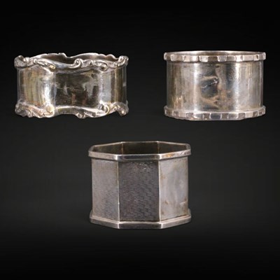 Lot 1134 - Three silver napkin rings, circa late 19th and...