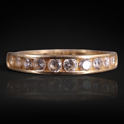 Lot 1252 - A 9 ct gold and cubic zirconia half-hoop...