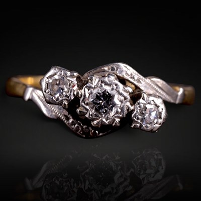 Lot 1254 - A vintage twist-set 3-stone diamond ring, the...