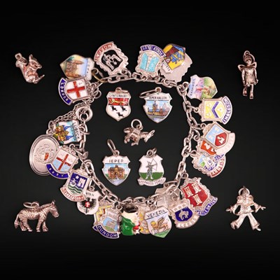 Lot 1217 - A vintage enamelled white metal charm bracelet,...