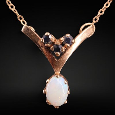 Lot 1323 - An opal, blue stone and 9 ct gold pendant...